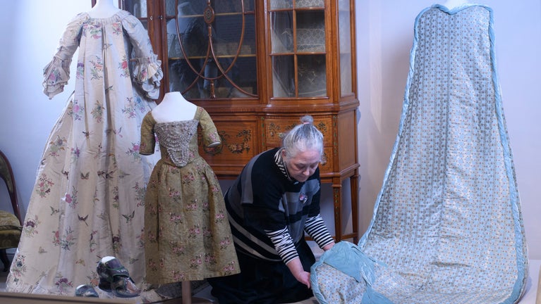 Shelley Tobin, Costume Curator, with a selection of dresses in the History off the Hanger fashion exhibition